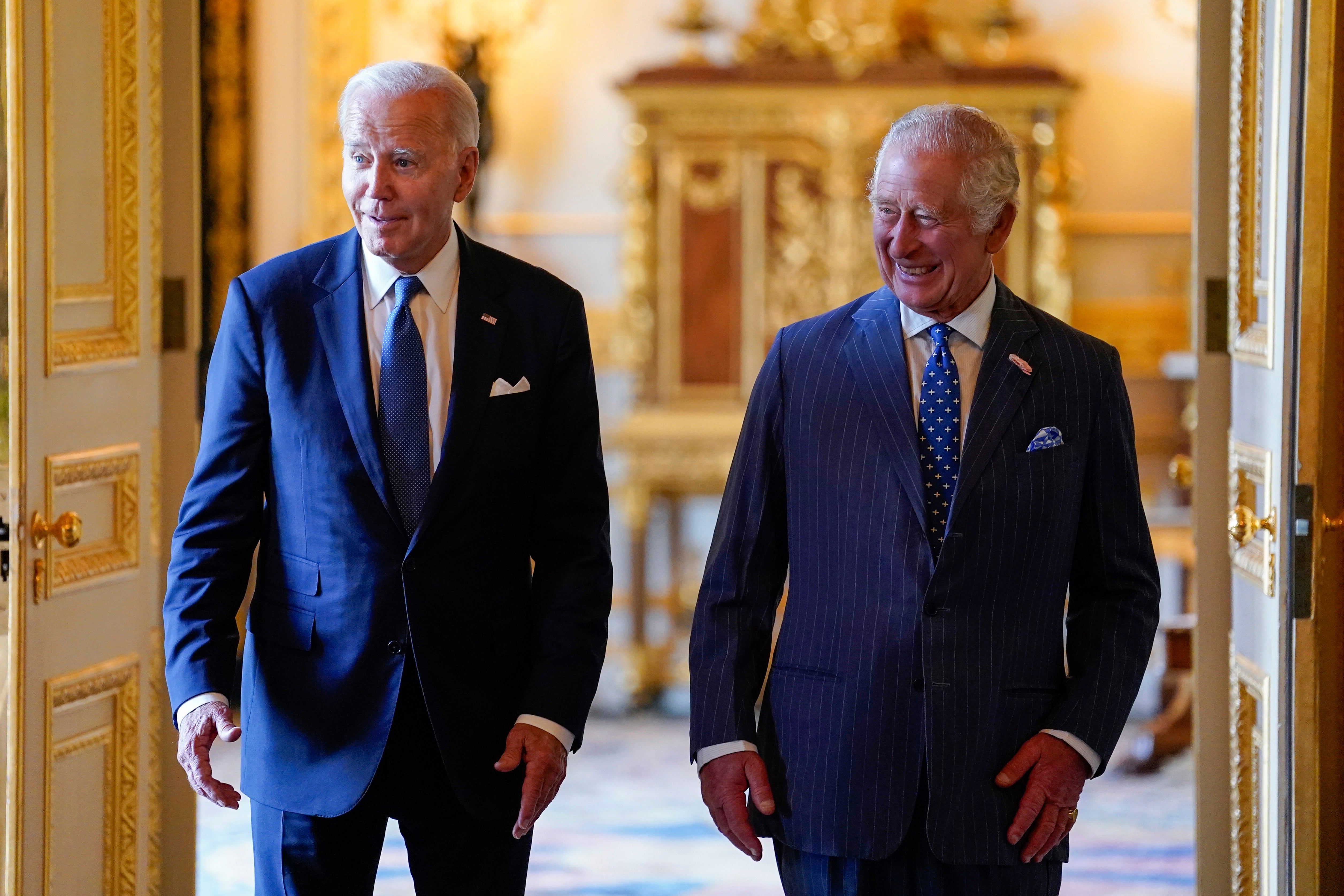 King Charles III, right, and Joe Biden arrive to meet participants of the Climate Finance Mobilisation forum in the Green Drawing Room at Windsor Castle, England, in July 2023
