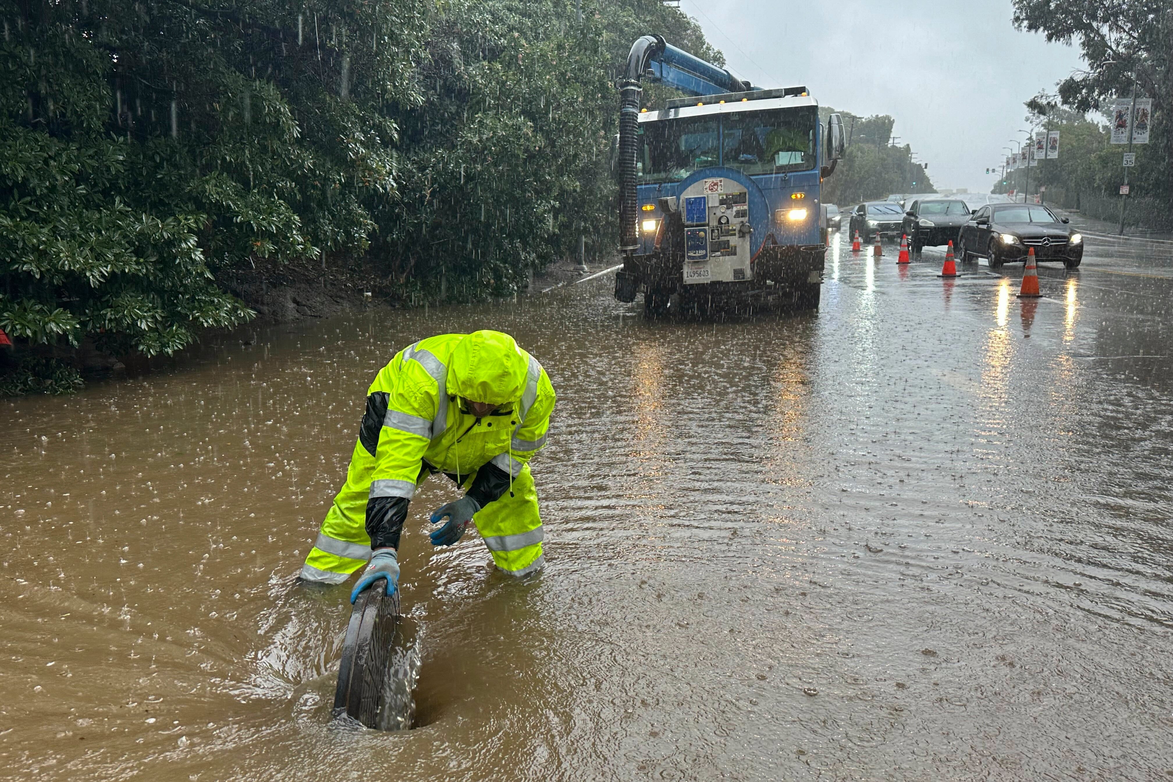An emergency responder works in California floodwaters