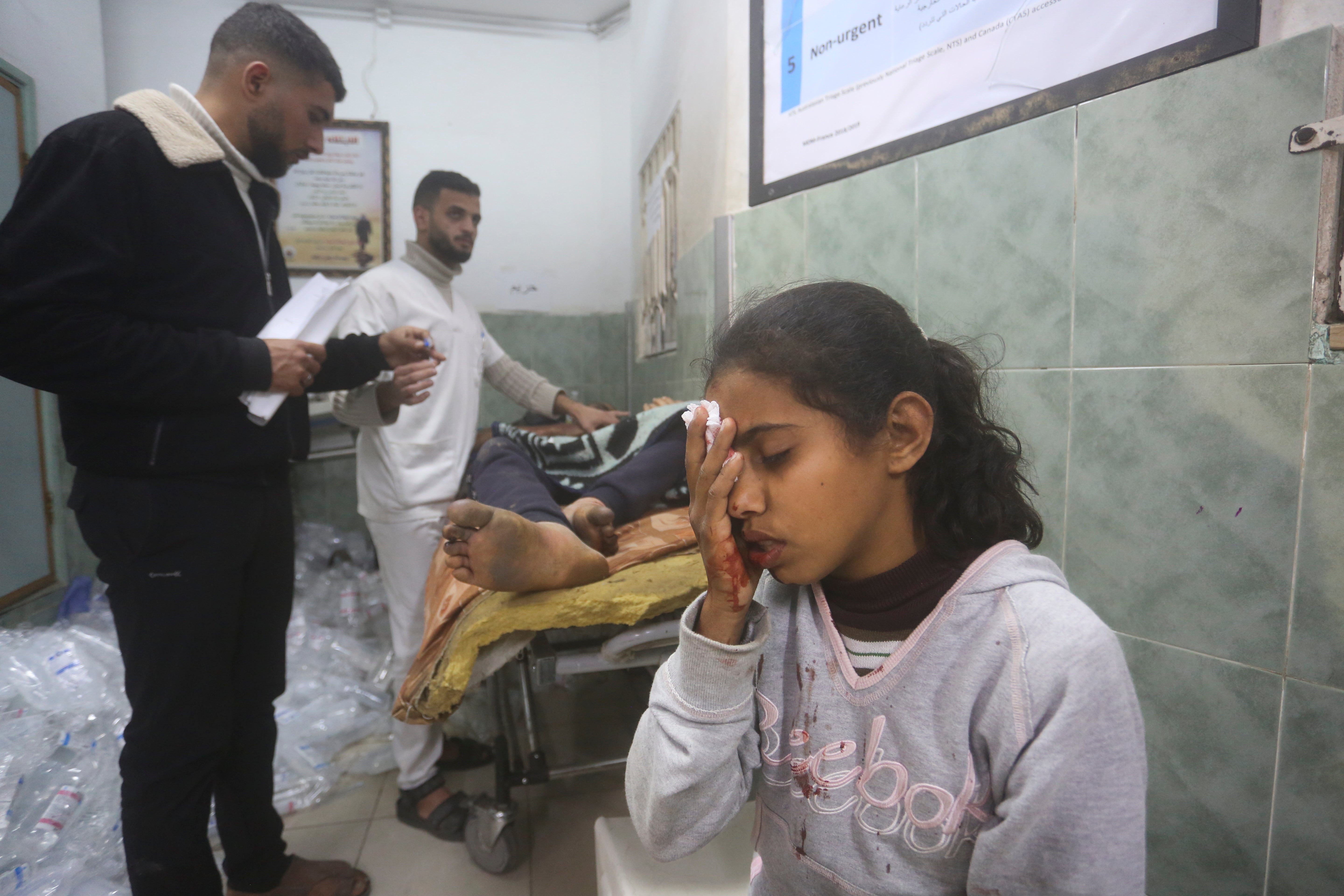 Palestinians wounded in the Israeli bombardment receive treatment in a hospital in Rafah, southern Gaza