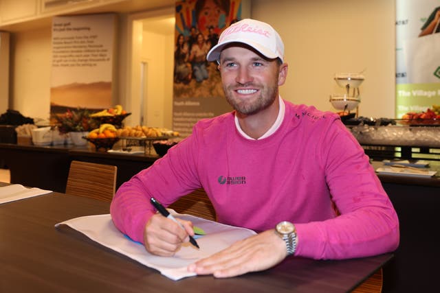 <p>Wyndham Clark signs pin flags after winning the AT&T Pebble Beach Pro-Am last week</p>