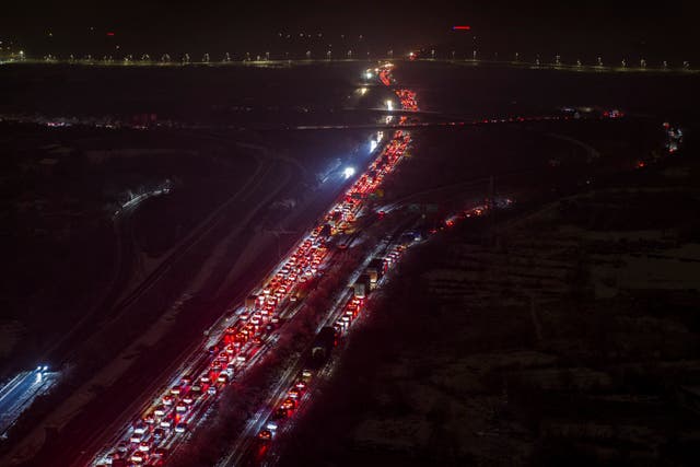 <p>Vehicles stranded on a snow covered motorway on the outskirts of Wuhan in central China’s Hubei province</p>