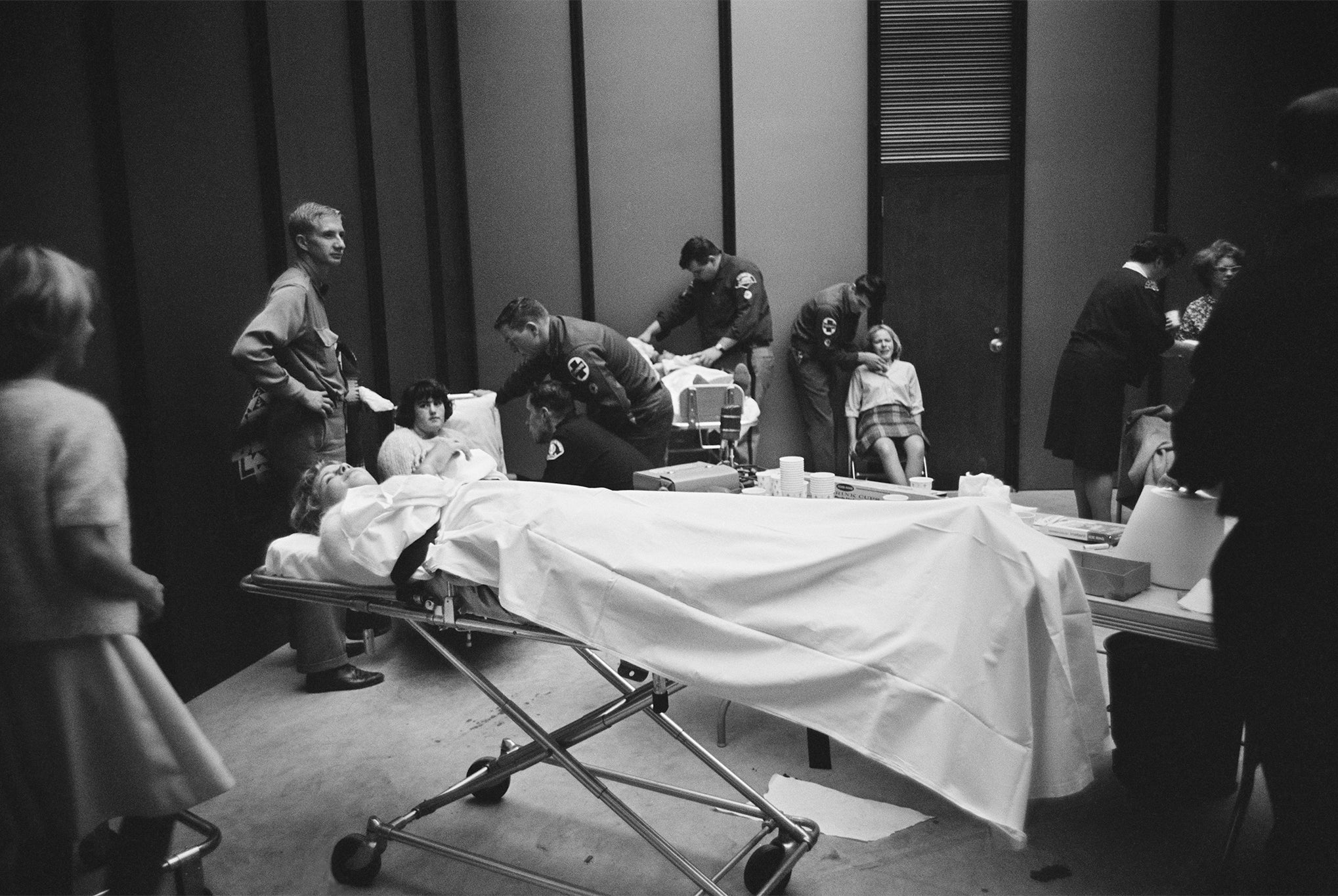 Beatles fans are attended to by paramedics, having been overcome during the group’s US tour, August 1964