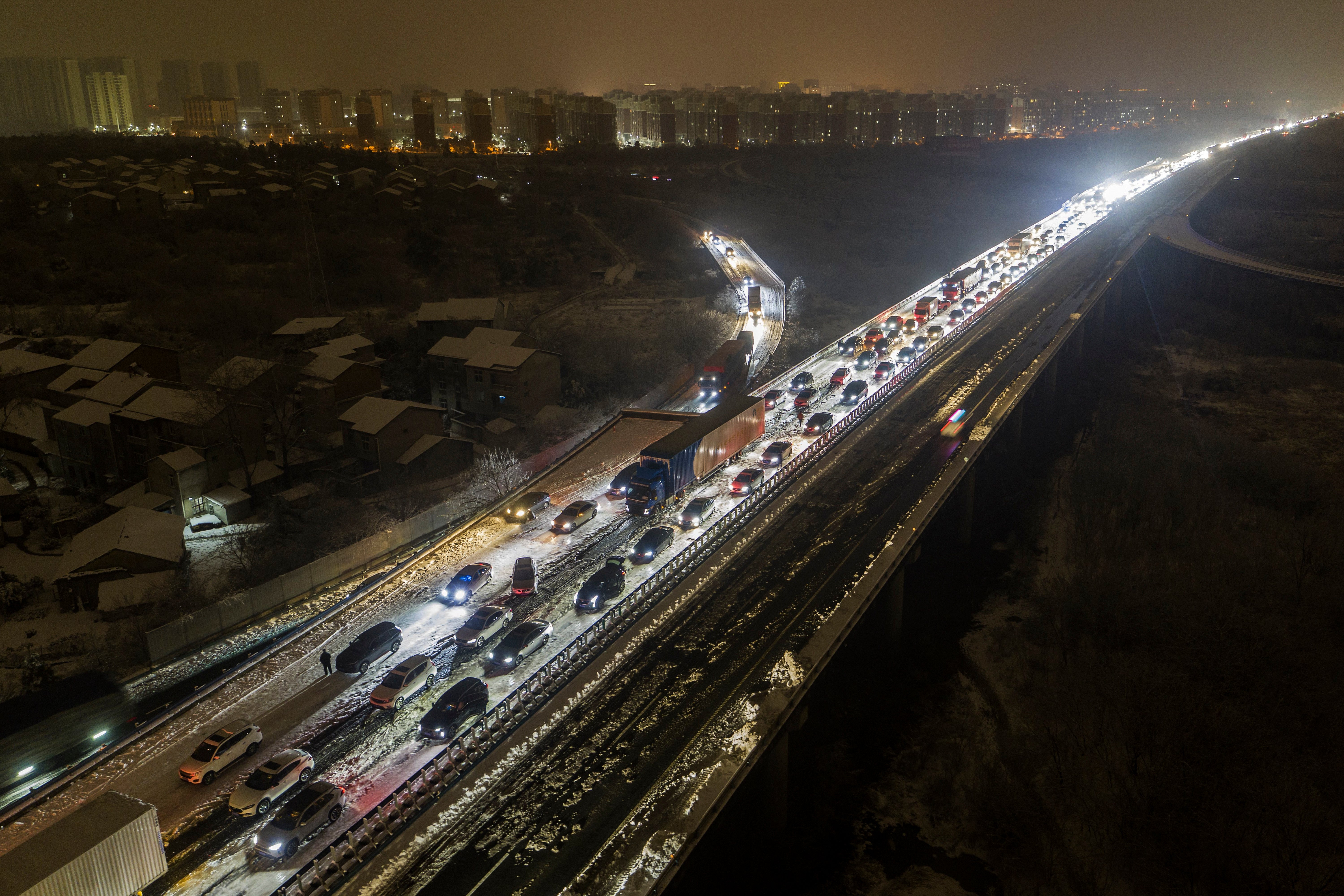 Vehicles stranded on a snow-covered highway on the outskirts of Wuhan in central China’s Hubei province