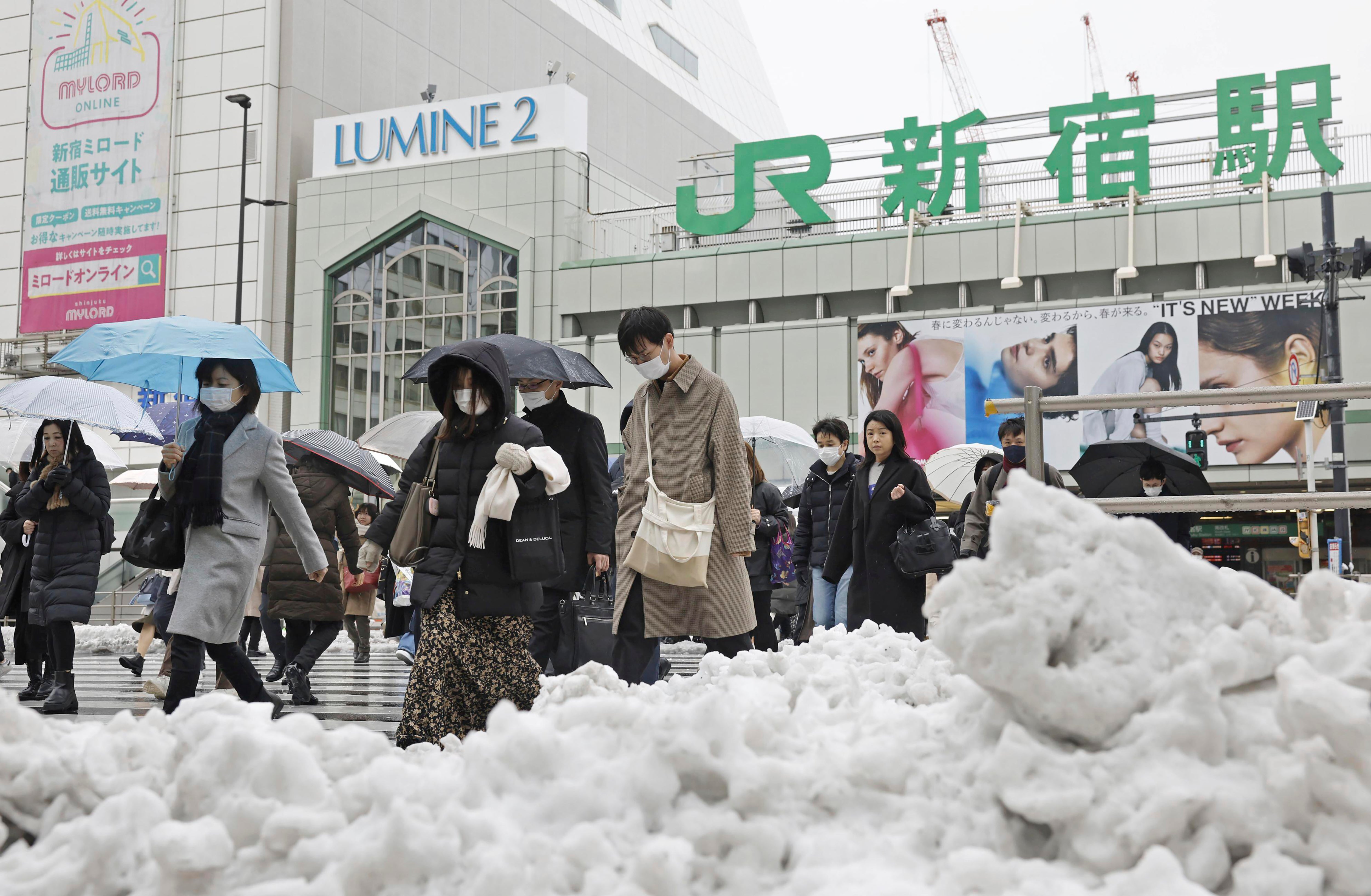 People make their way on a street in Tokyo on Tuesday