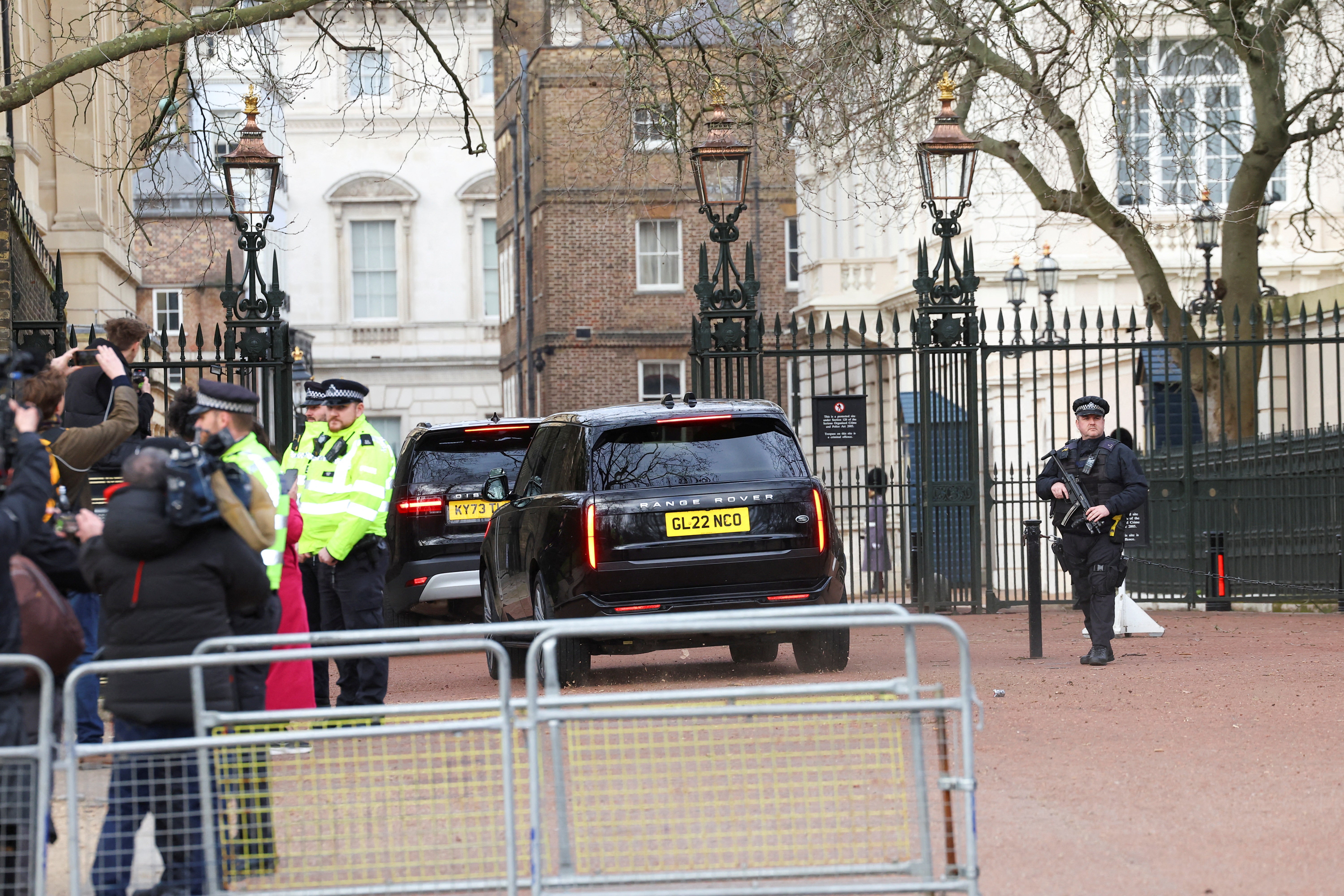 A car believed to be transporting Prince Harry enters Clarence House, the home of King Charles