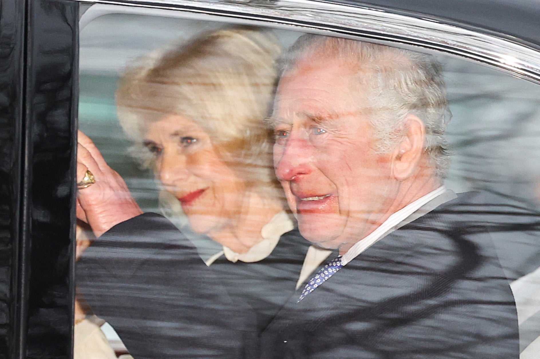Charles and Camilla wave to the crowds gathered on The Mall