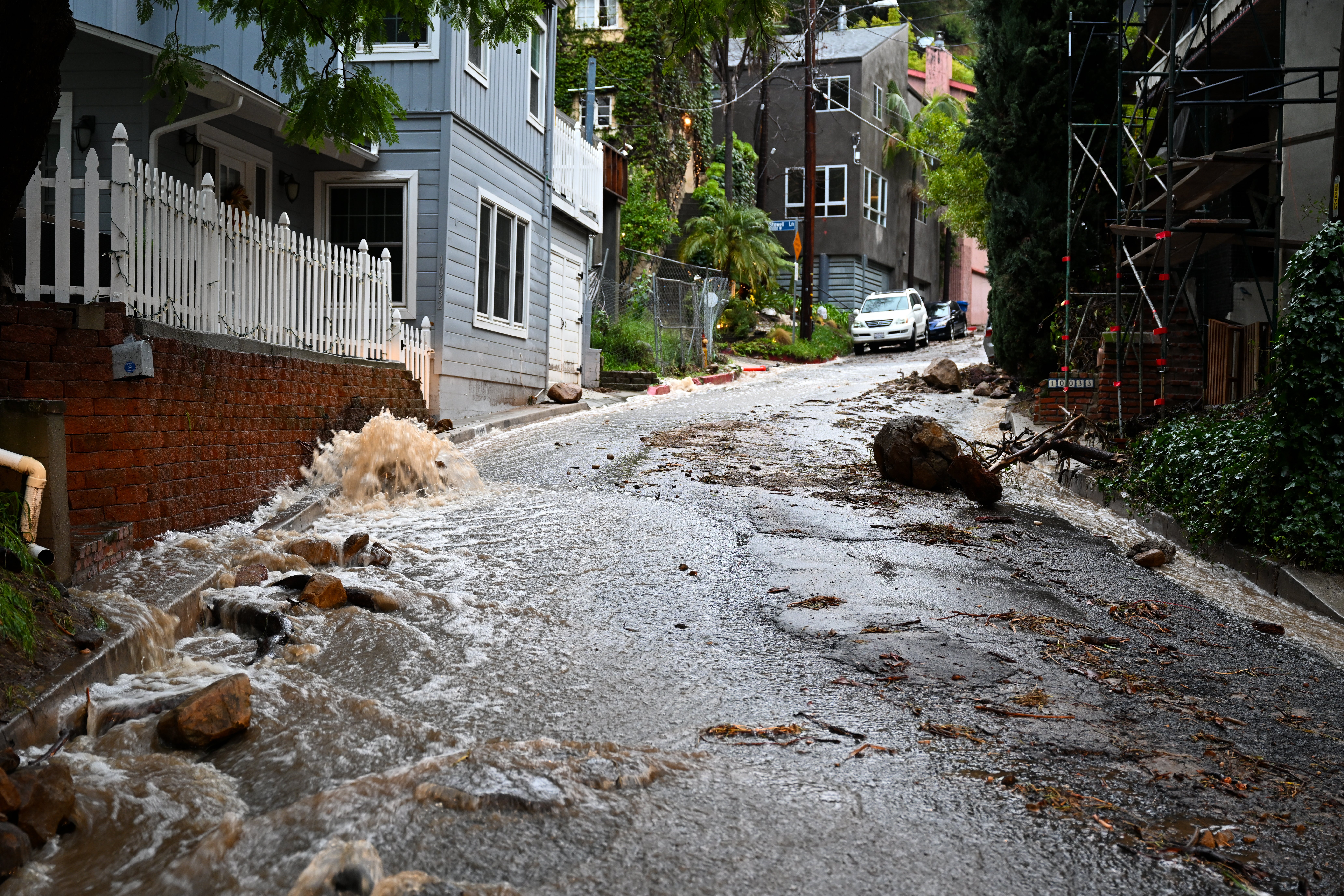 Floodwaters rush down a street in Los Angeles’ Beverly Crest neighbourhood on Monday