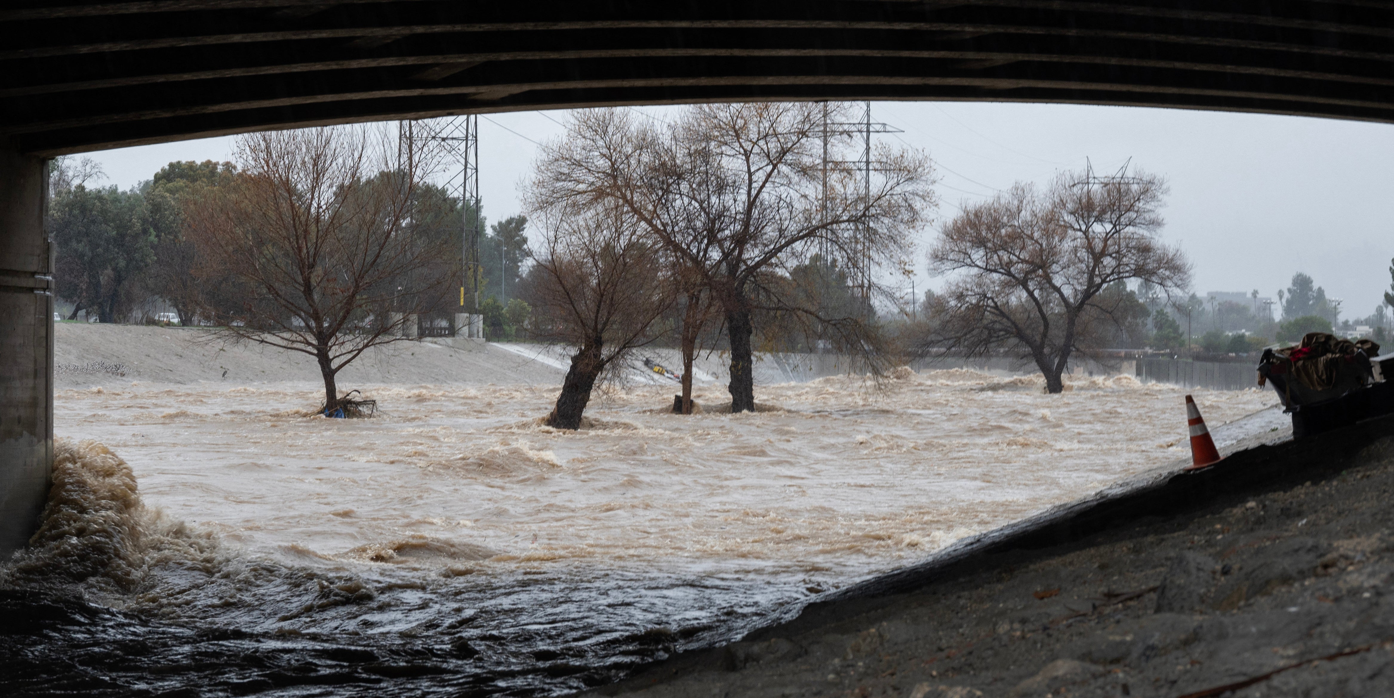 Floodwaters rush through an underpass in Los Angeles, California on Monday