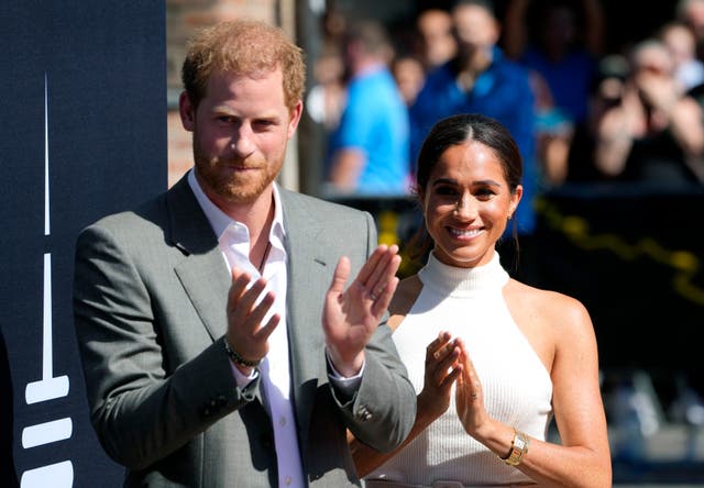<p>Clap happy: Harry and Meghan on a visit to Dusseldorf </p>