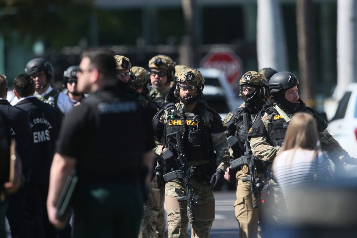 A SWAT team sniper killed a bank hostage-taker armed with a knife, sheriff says
