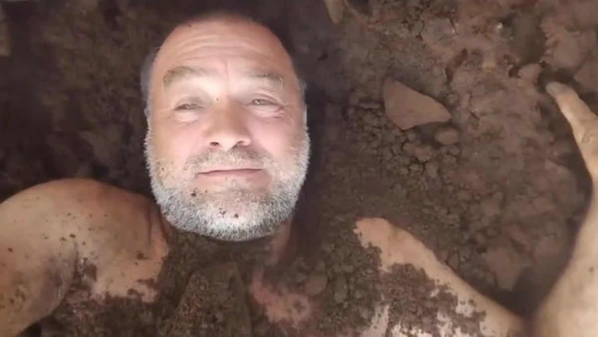 Former Argentine MP buries himself in dirt to protest President Milei legislation in bizarre video