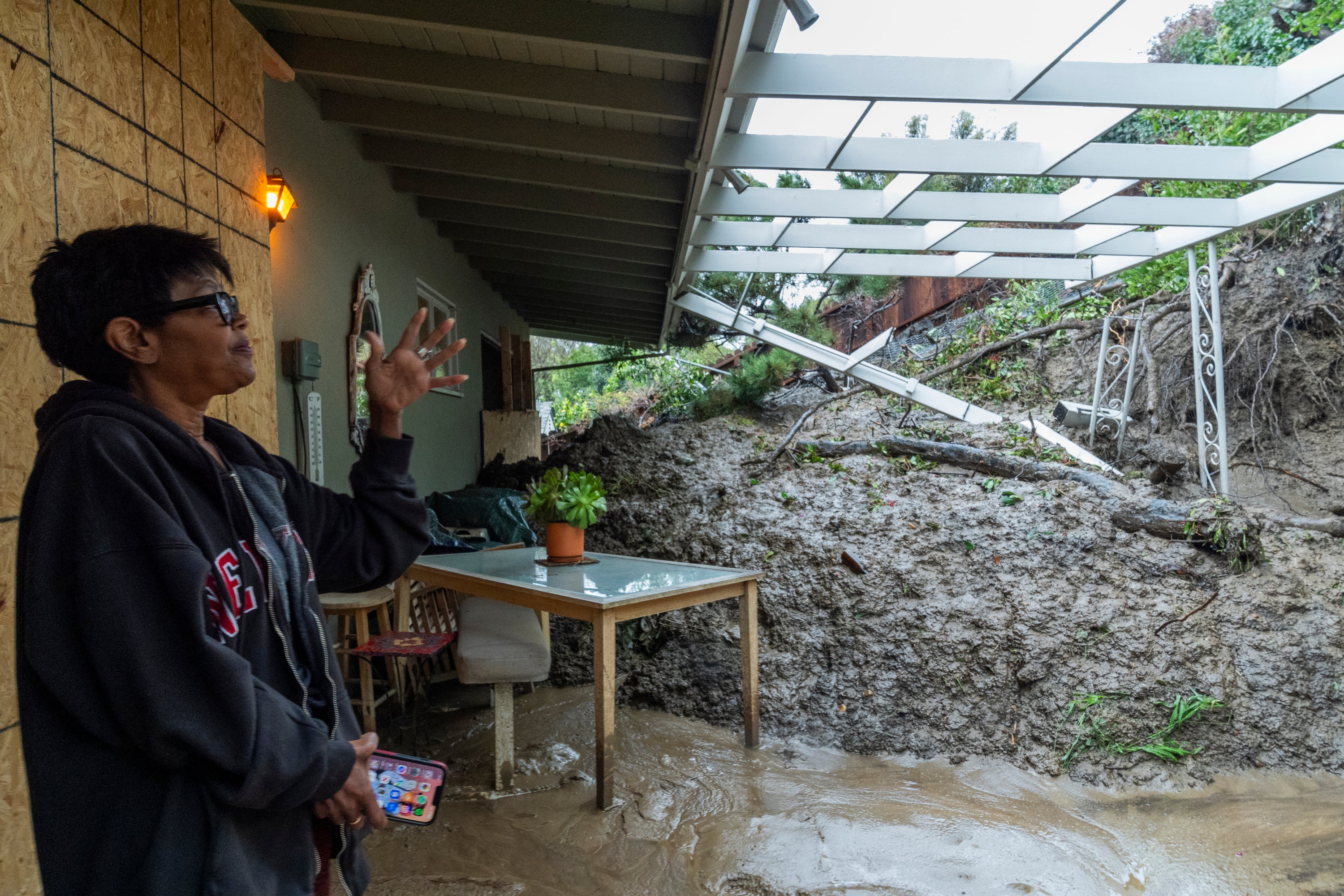 Home owner Dion Peronneau recounts how she was awoken by the sound of cracking around 4am on Monday morning as a mudflow forced its way into her home early in the Baldwin Hills area of Los Angeles