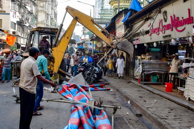 <p>Mumbai’s Brihanmumbai Municipal Corporation (BMC) authorities demolishing structures on the facade of an eatery near Minara Masjid mosque in Mumbai in exercise to tear down several Muslim-owned makeshift shopfronts after religious clashes sparked by a divisive Hindu temple opened by Narendra Modi</p>