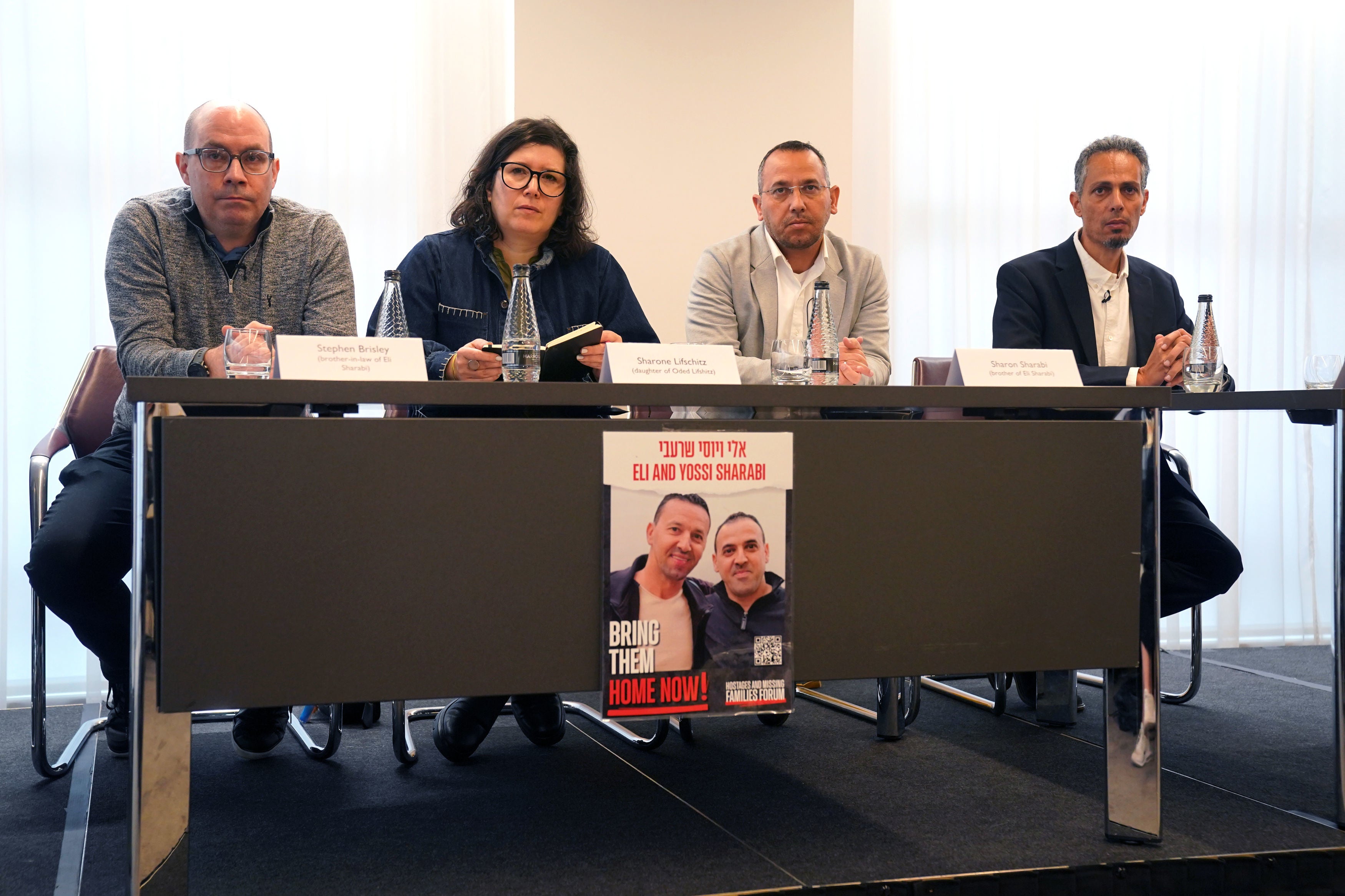 <p>(Left-right) Stephen Brisley, Sharone Lifschitz, Sharon Sharabi and Raz Matalon who are family members of four people taken hostage by Hamas in Israel on 7 October, speak during a press conference</p>