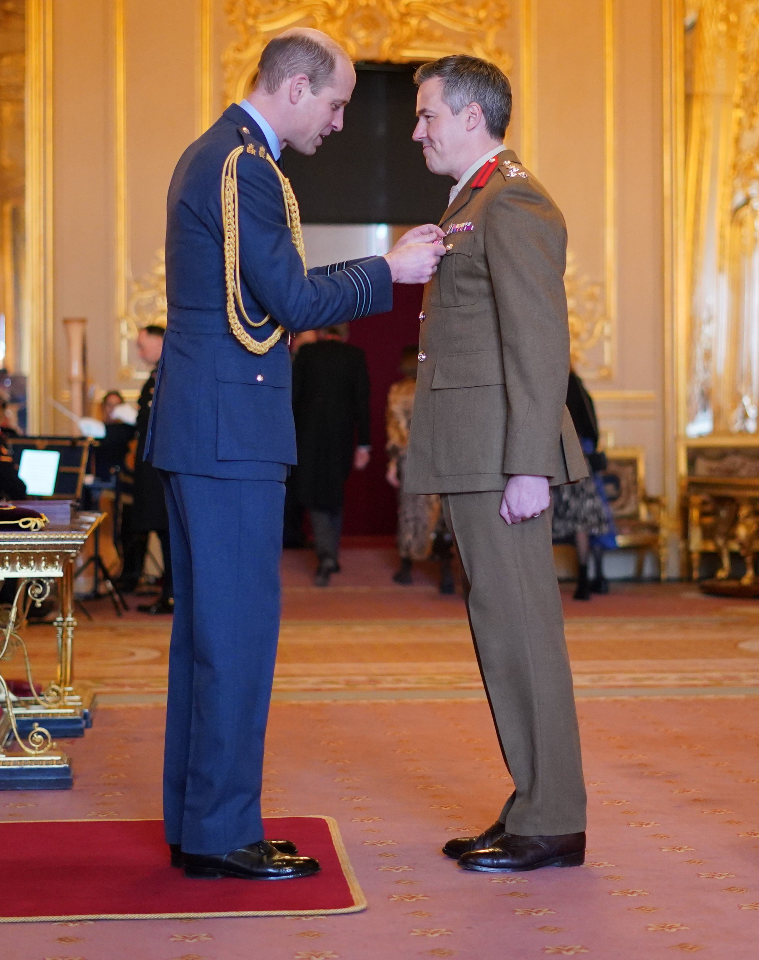 Brigadier Tobias Lambert is made an Officer of the Order of the British Empire by the Prince of Wales at Windsor Castle