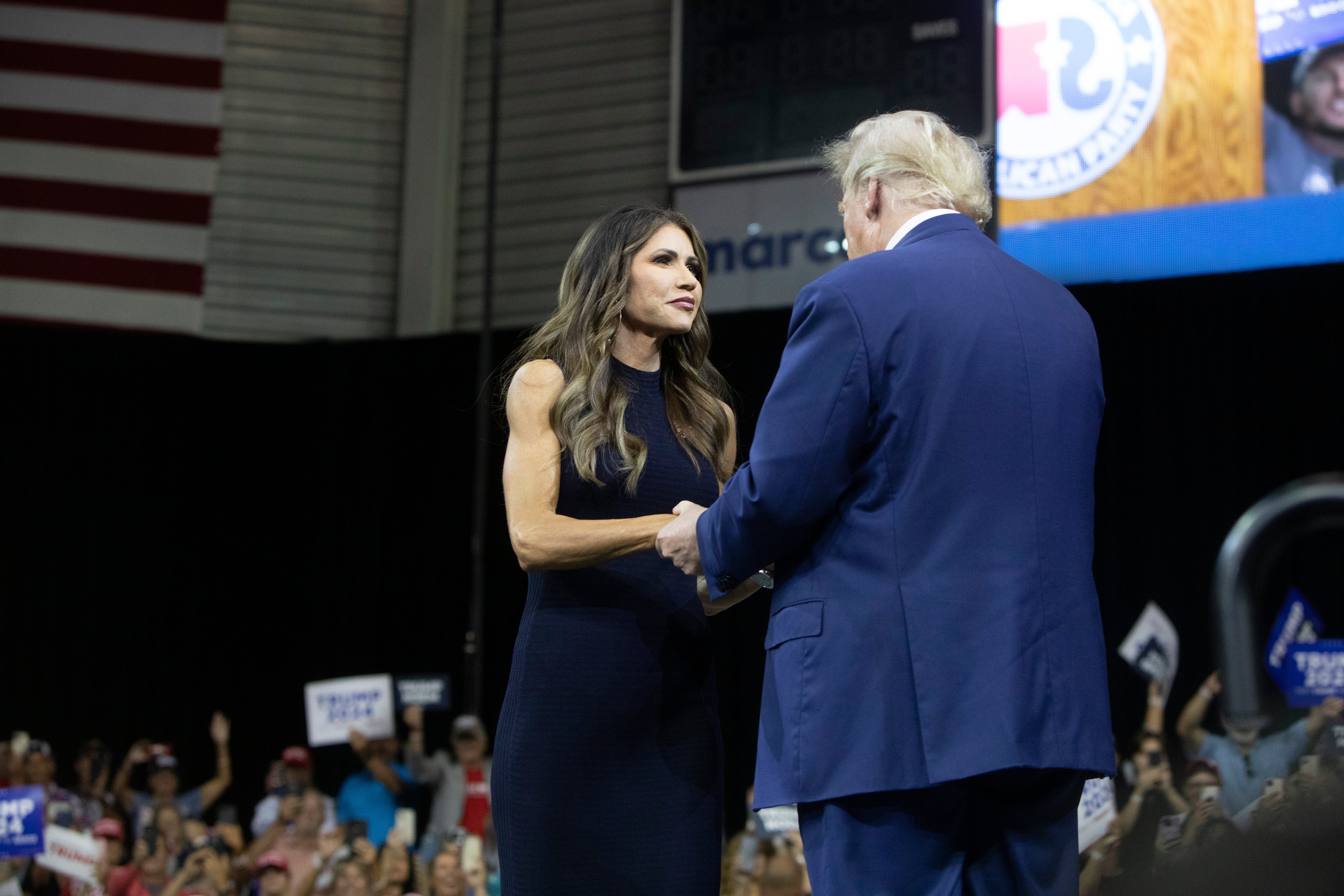 Kristi Noem greets Donald Trump at his rally in South Dakota in September 2023