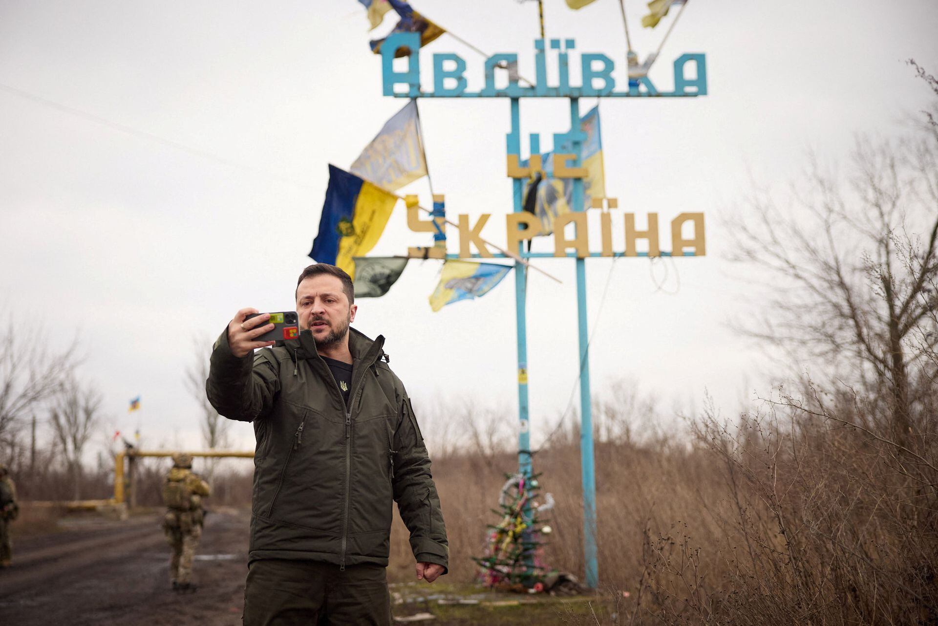 Ukraine’s President Volodymyr Zelensky takes a video in front of a road sign with the words ‘Avdiivka this is Ukraine’