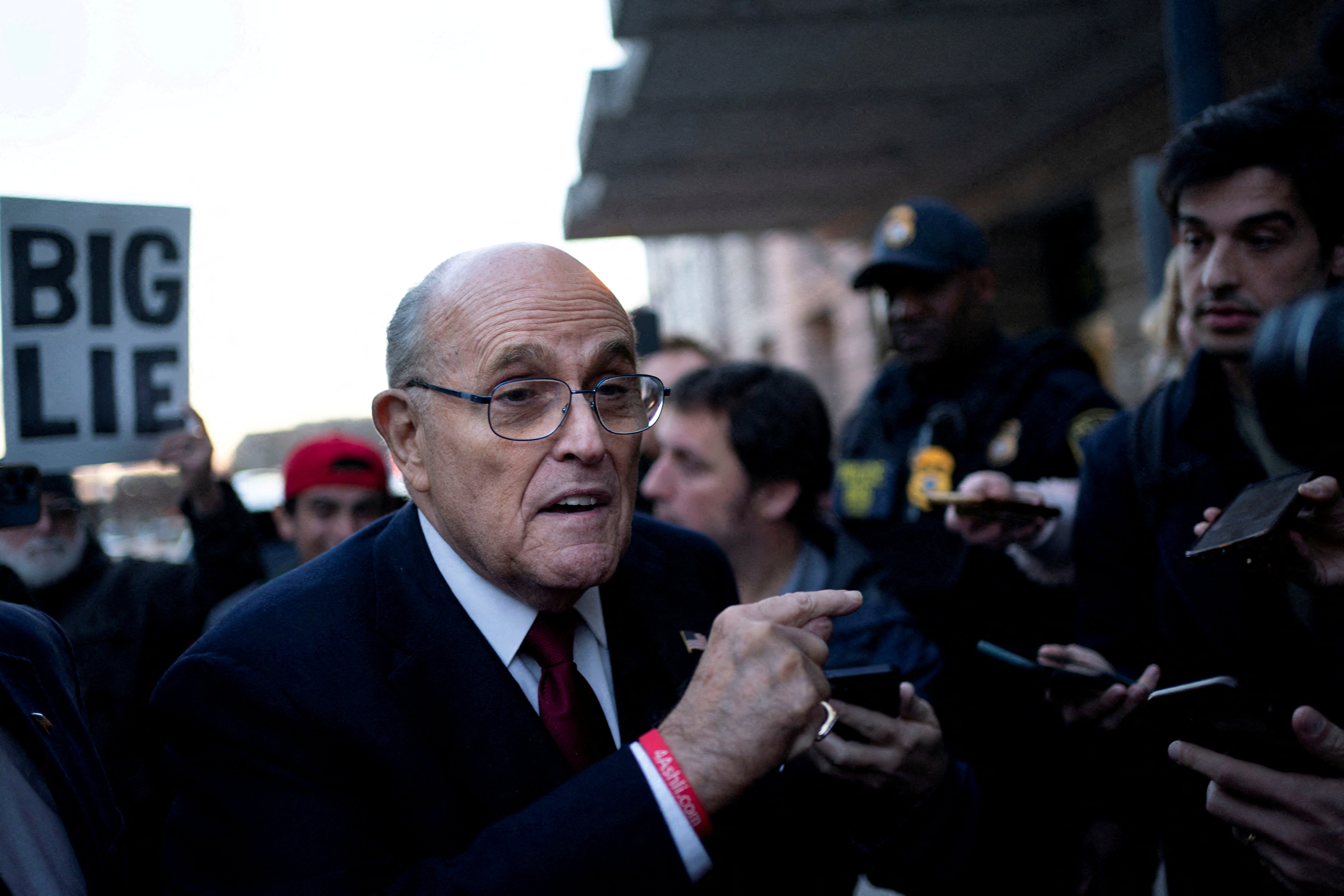 Rudy Giuliani was pictured leaving a courthouse in Washington DC after a jury ordered him to pay $148m for defaming a pair of election workers.