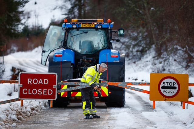 <p>A plough man closes the snow gates on the A836 Scourie road</p>