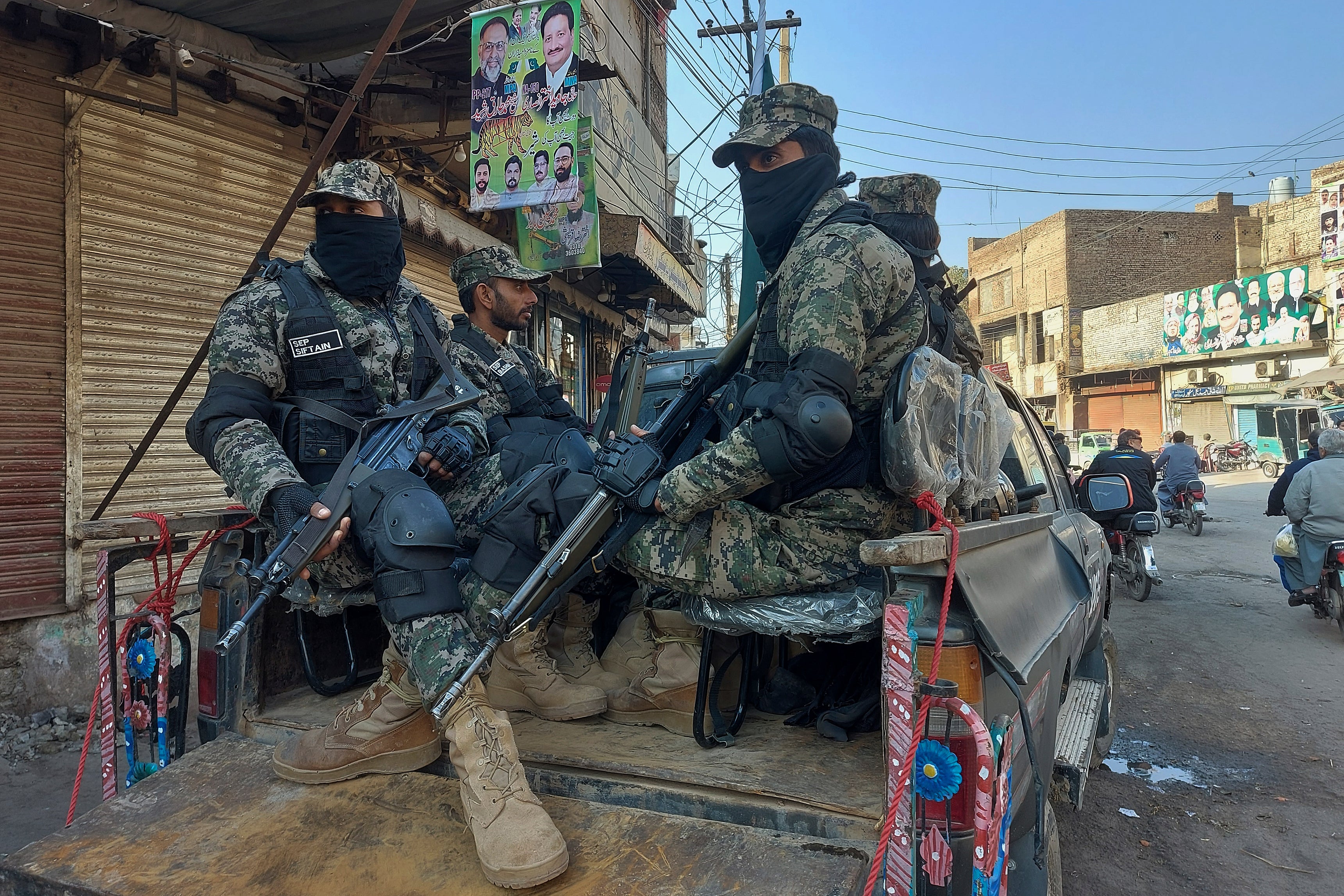 Paramilitary soldiers guard outside a polling station to ensure security during the country's parliamentary elections in Multan