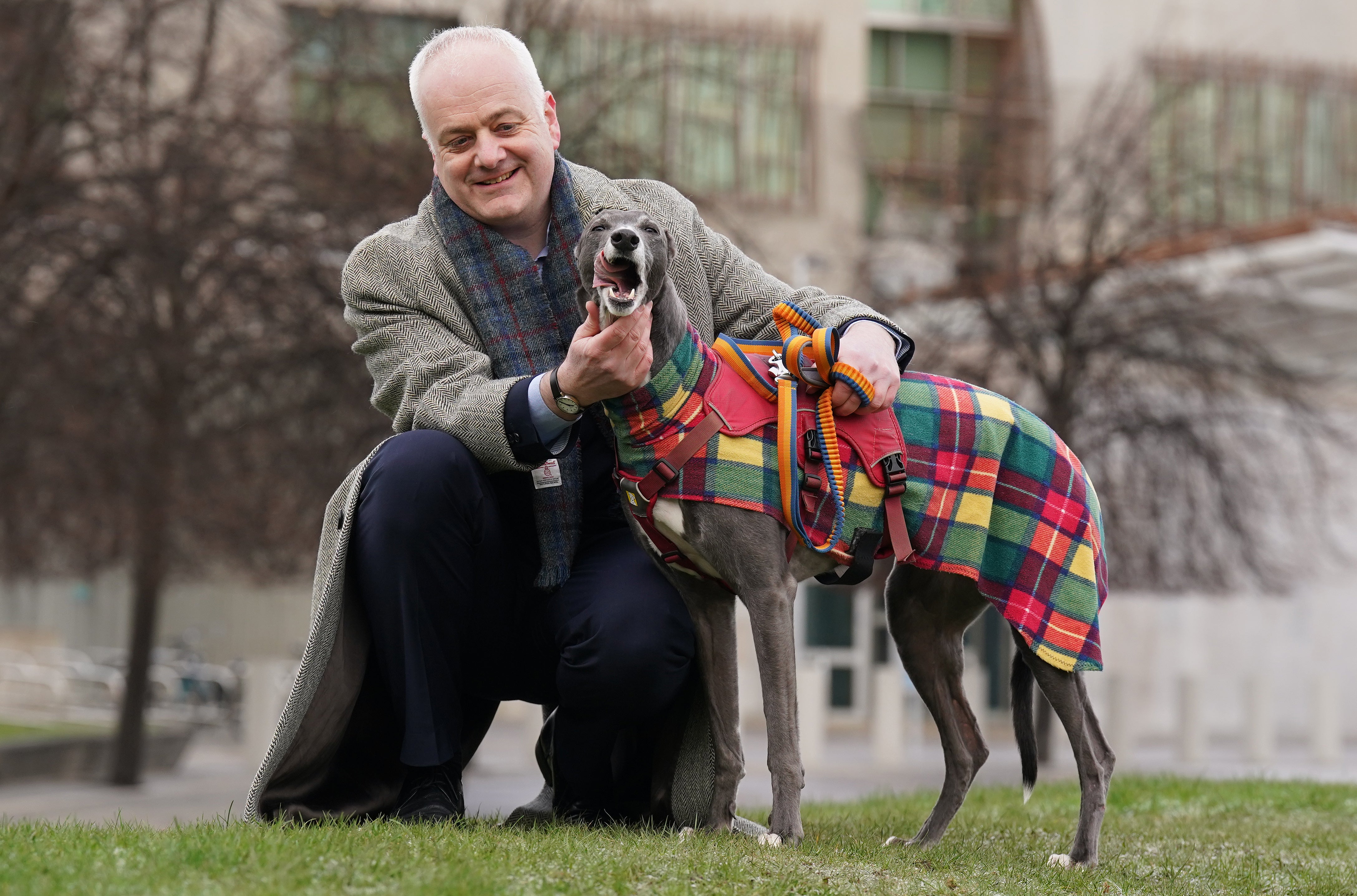 Scottish Green MSP Mark Ruskell stands with former greyhound racing dog