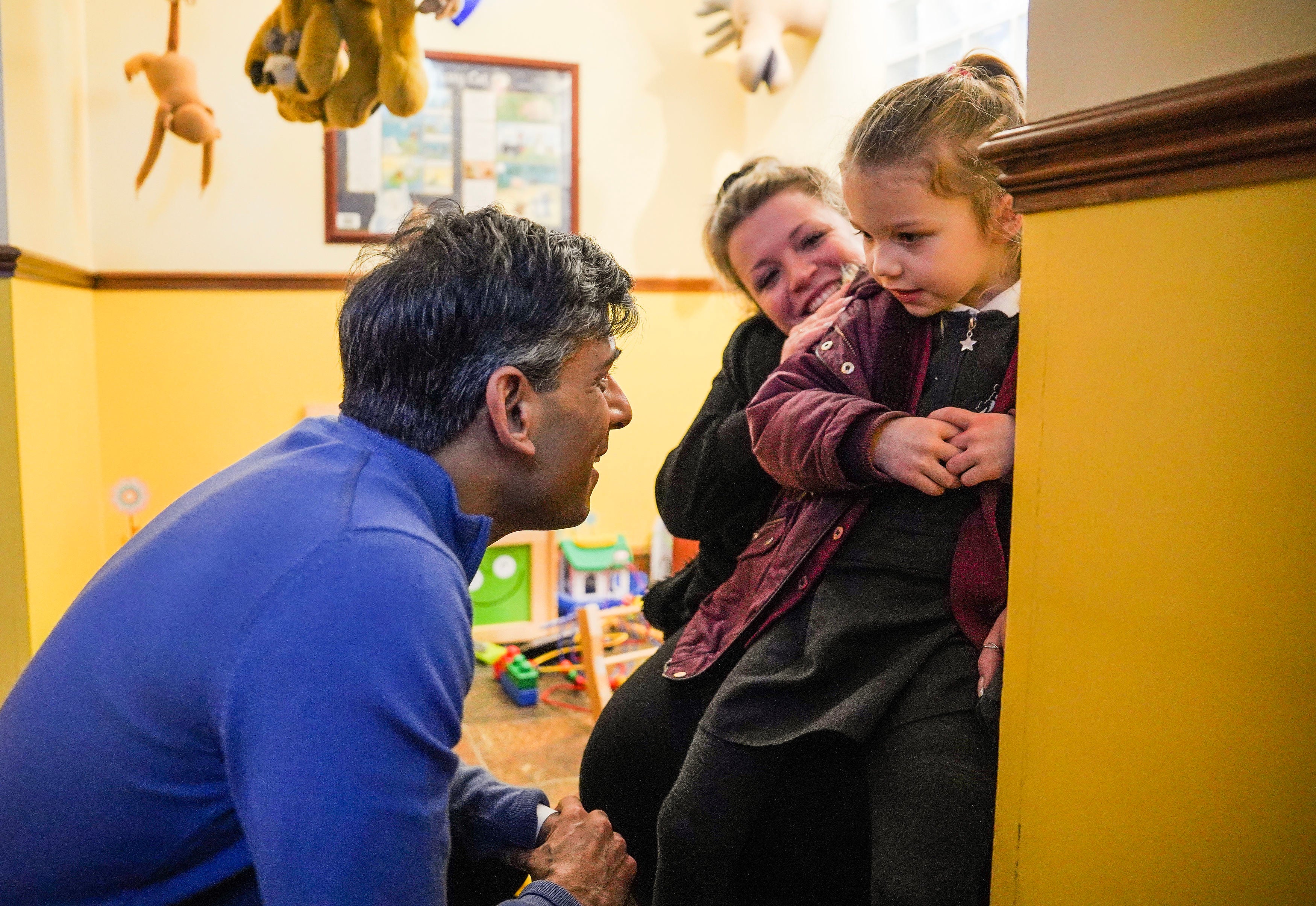 File photo: PM speaks to a young girl while visiting a dental surgery on Thursday