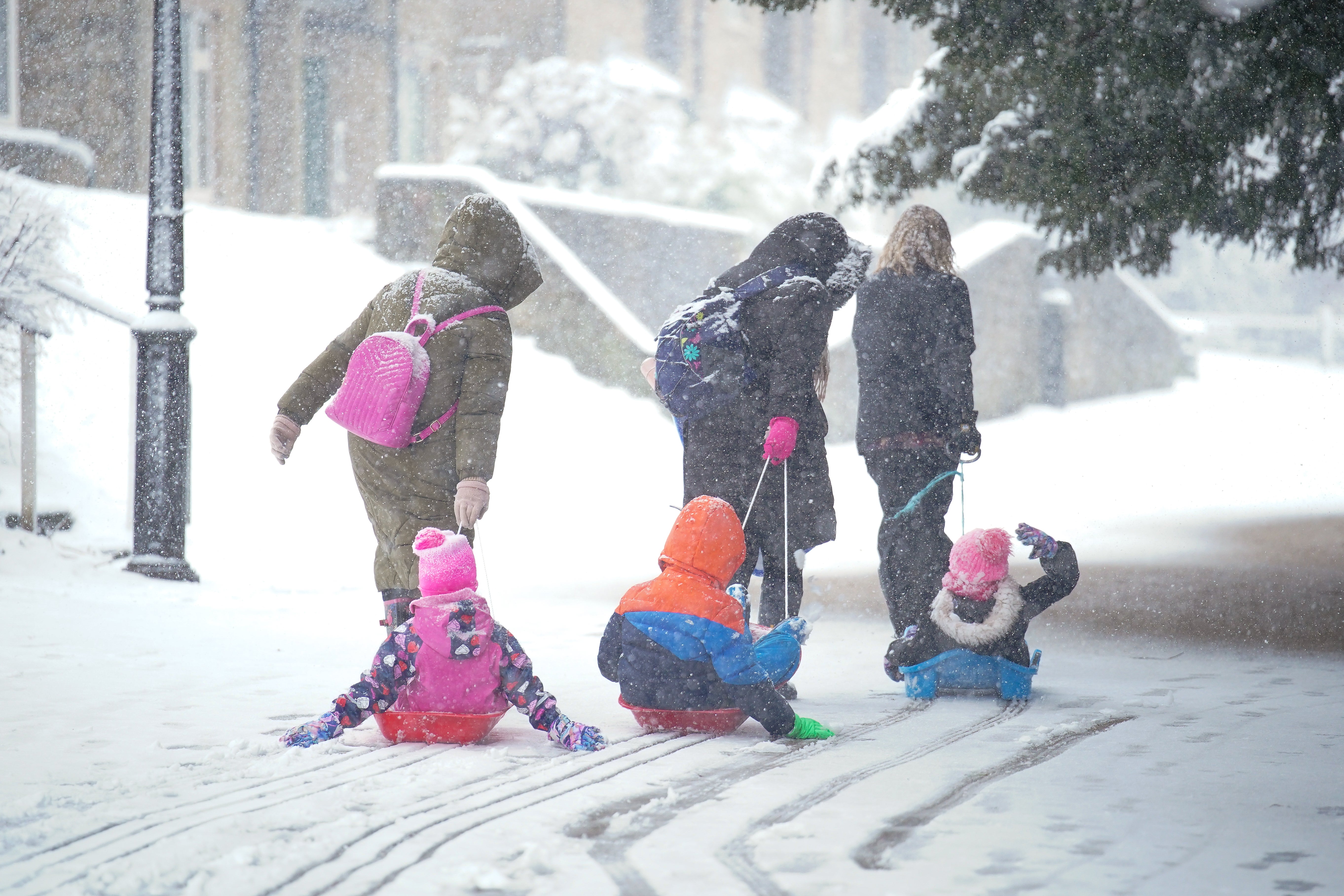 pChildren being pulled on sleds in the Peak District /p