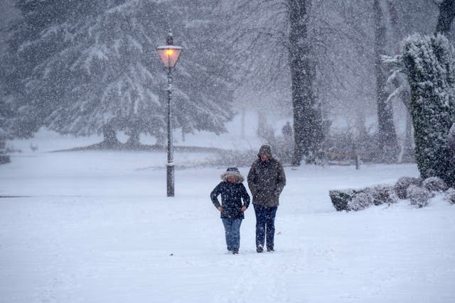 <p>BUXTON, UNITED KINGDOM - FEBRUARY 08: People walk through the snow in Pavilion Gardens on February 08, 2024 </p>