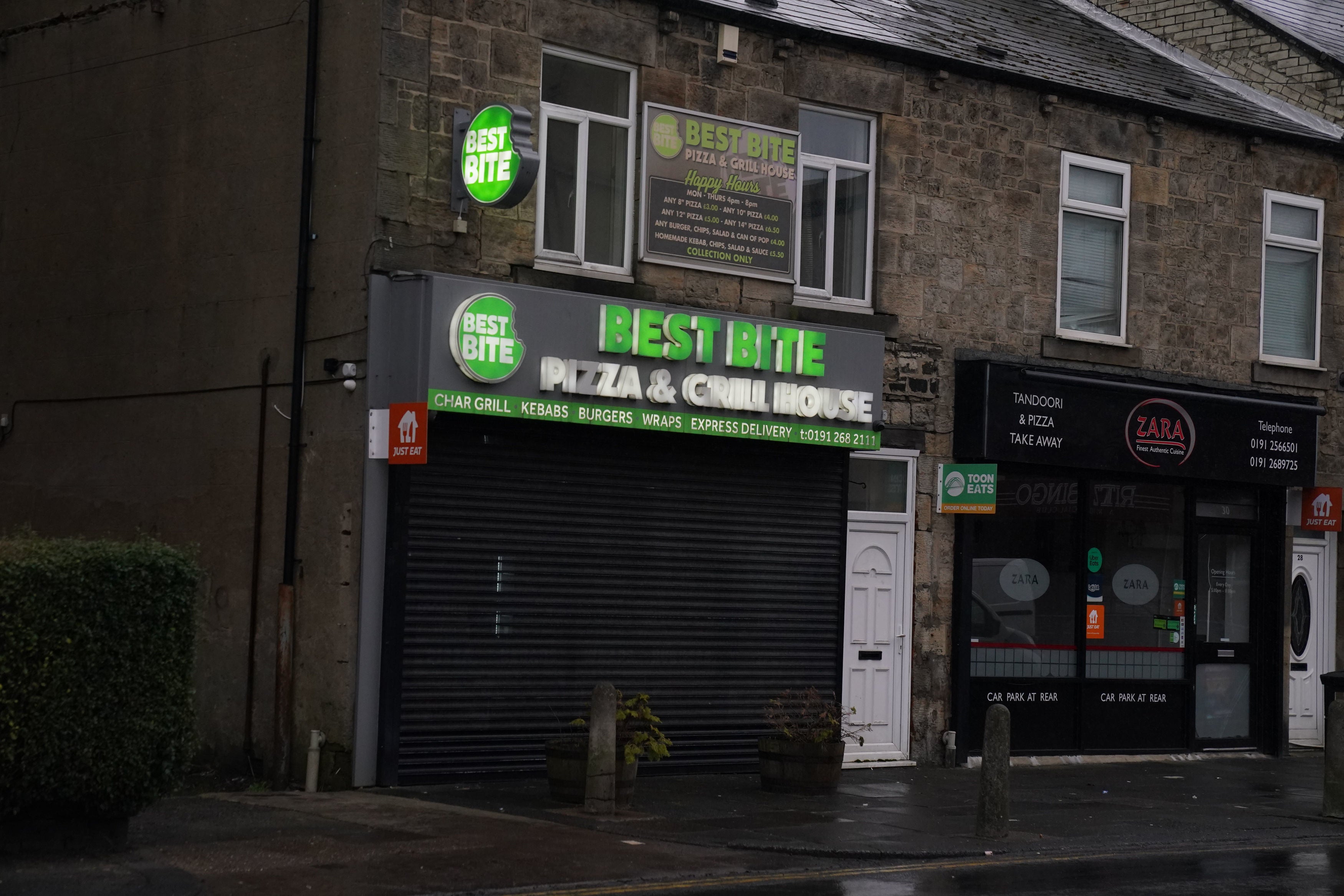 <p>A view of the Best Bite pizza and grill house in the Forest Hall area of Newcastle upon Tyne, one of two addresses raided by armed police as part of their search for Clapham alkali attack suspect Abdul Ezedi</p>