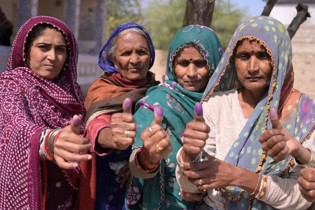 <p>Women shows their inked thumbs after casting their ballots to vote at a polling station during Pakistan’s national elections in Hyderabad city</p>