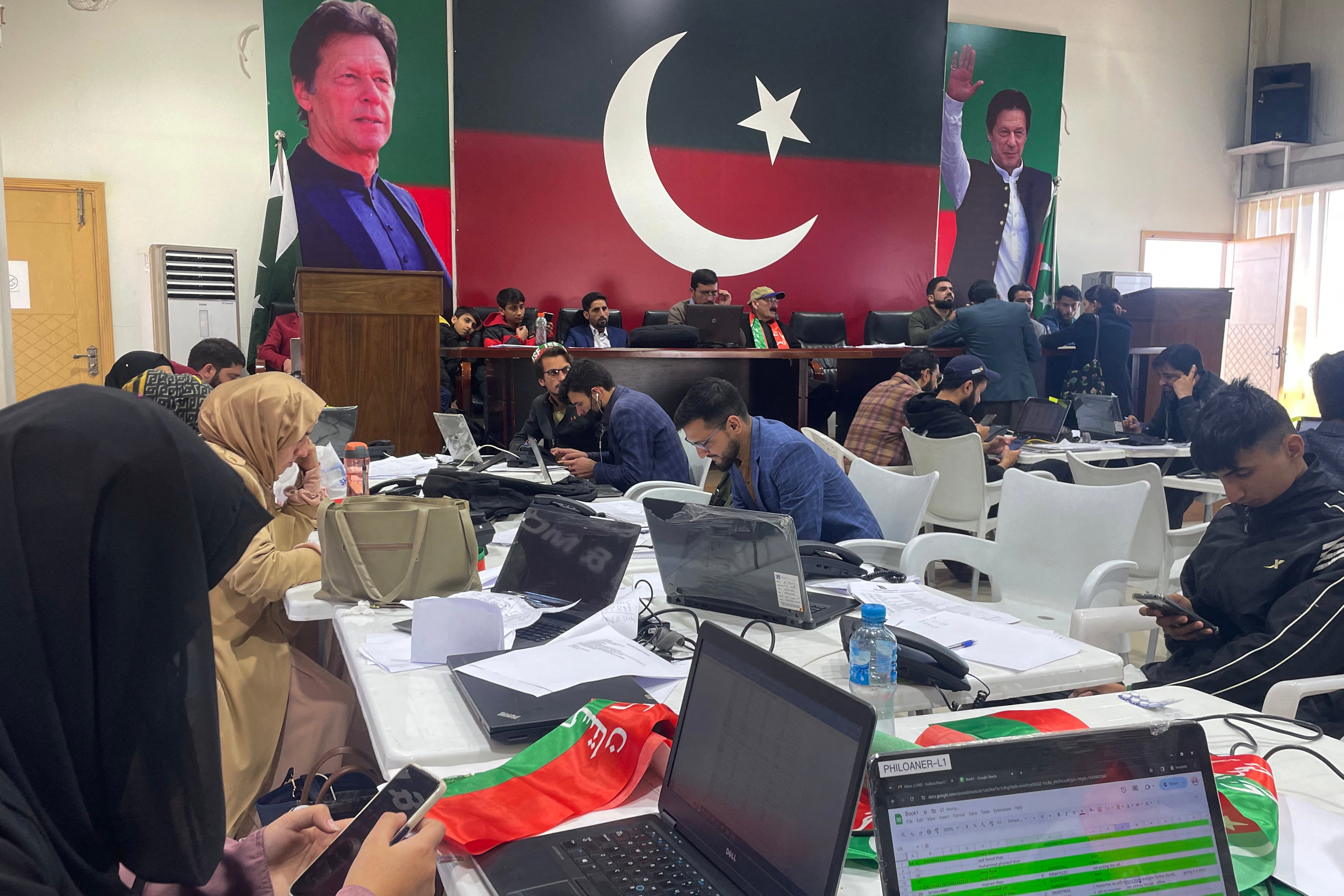 Workers are pictured at the central election monitoring cell of Pakistan Tehreek-e-Insaf (PTI) at the party office in Islamabad