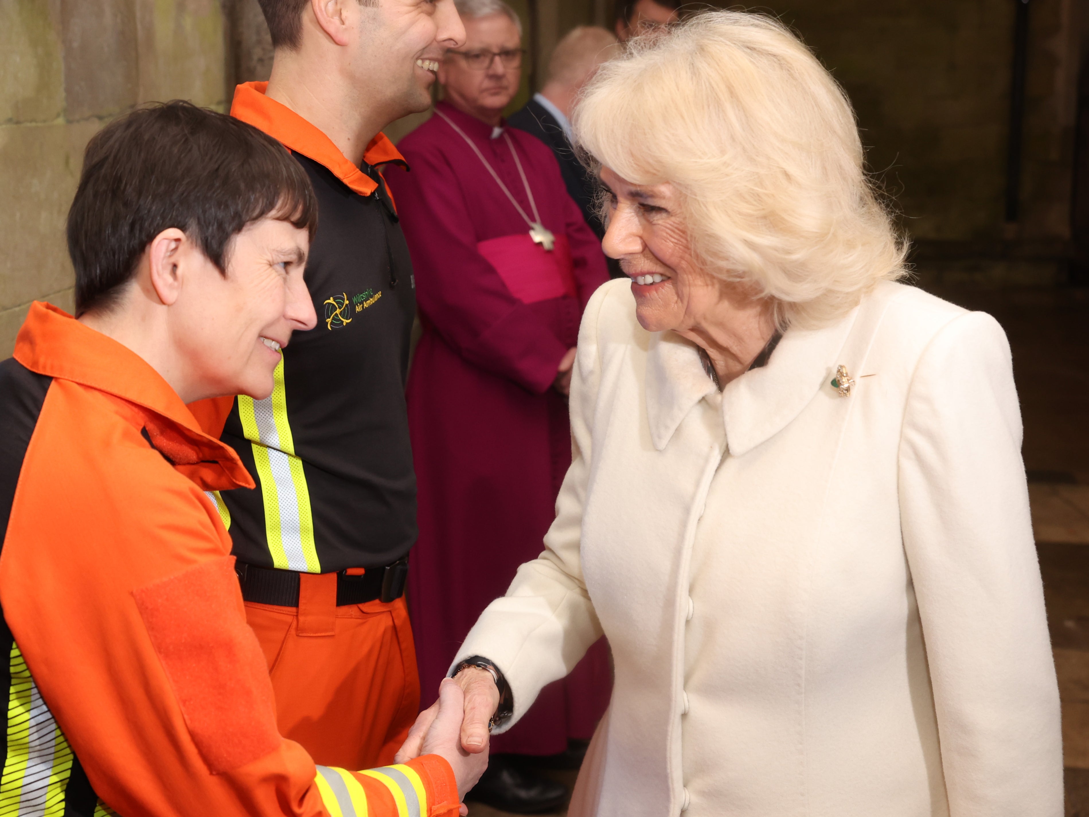 Queen Camilla is greeted by air ambulance charity representatives