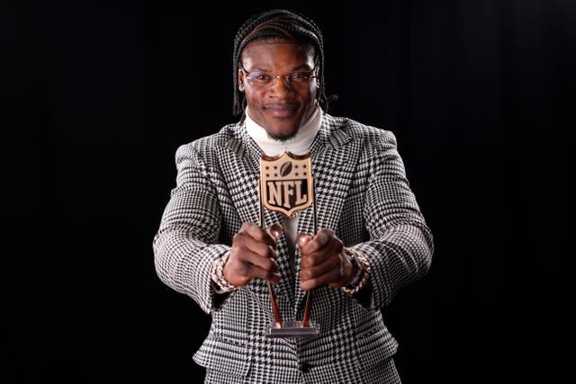 Baltimore Ravens’ Lamar Jackson poses after winning the award (Matt York/AP)