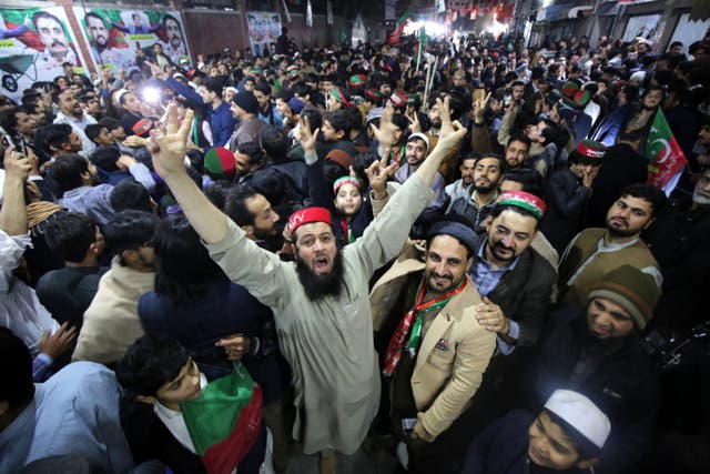 <p>Supporters of  the former prime minister’s PTI party cheer unofficial preliminary partial results in Peshawar</p>