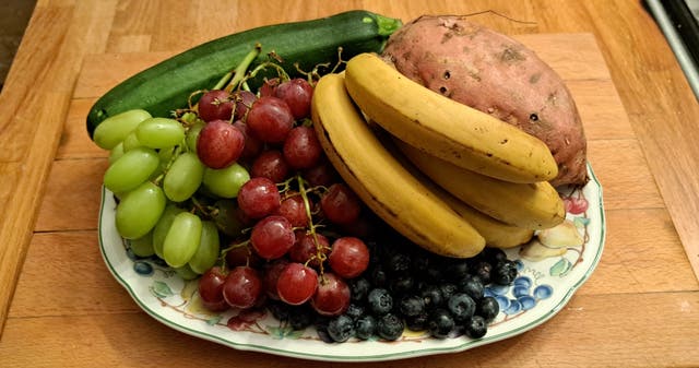 <p>‘I bought grapes, bananas, sweet potatoes \ Blueberries and courgettes and walked the many shelves of sugar snacks to pay’ </p>