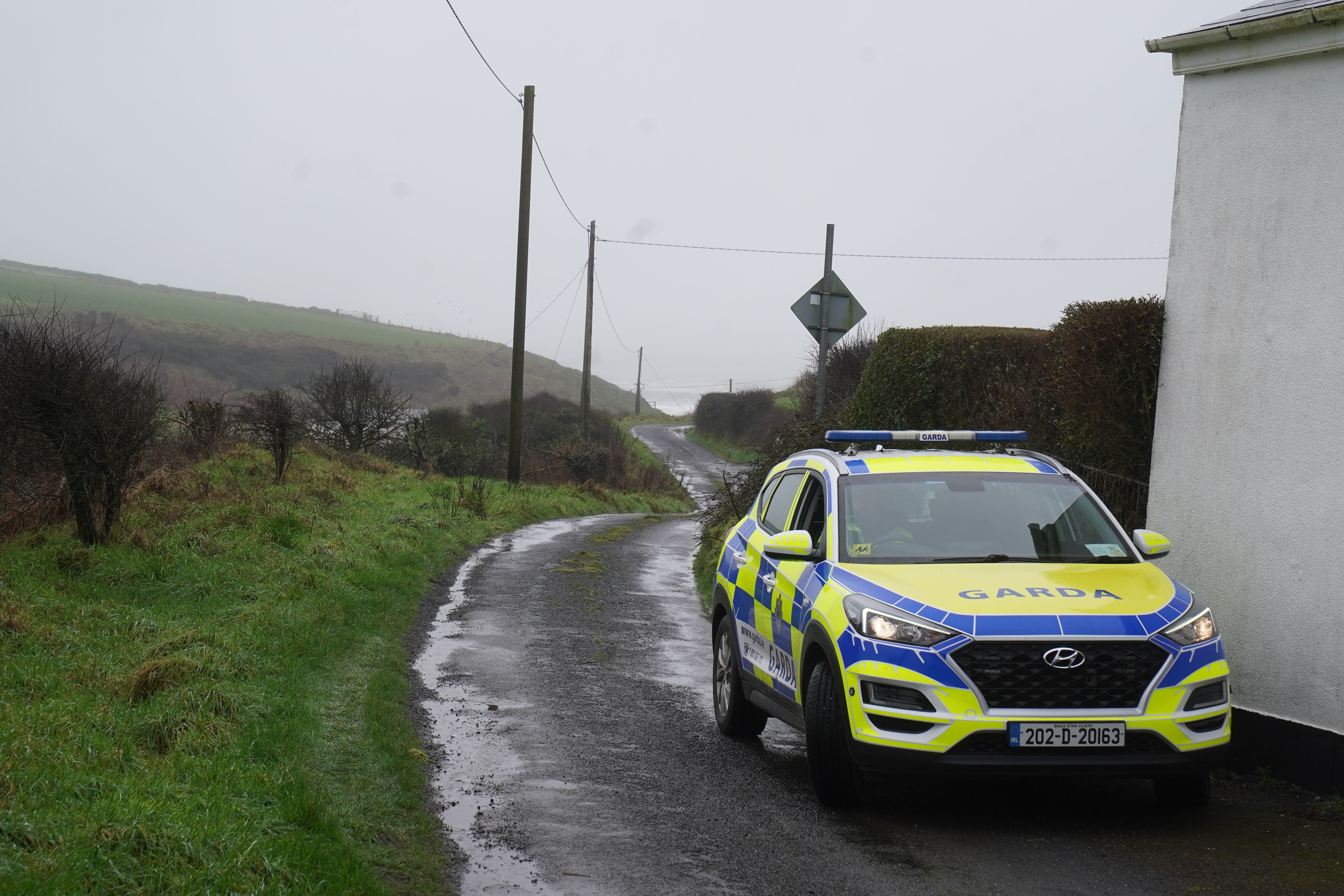 A garda car parked close to the scene in the Rathmoylan area of Dunmore East, Co Waterford (Brian Lawless/PA)