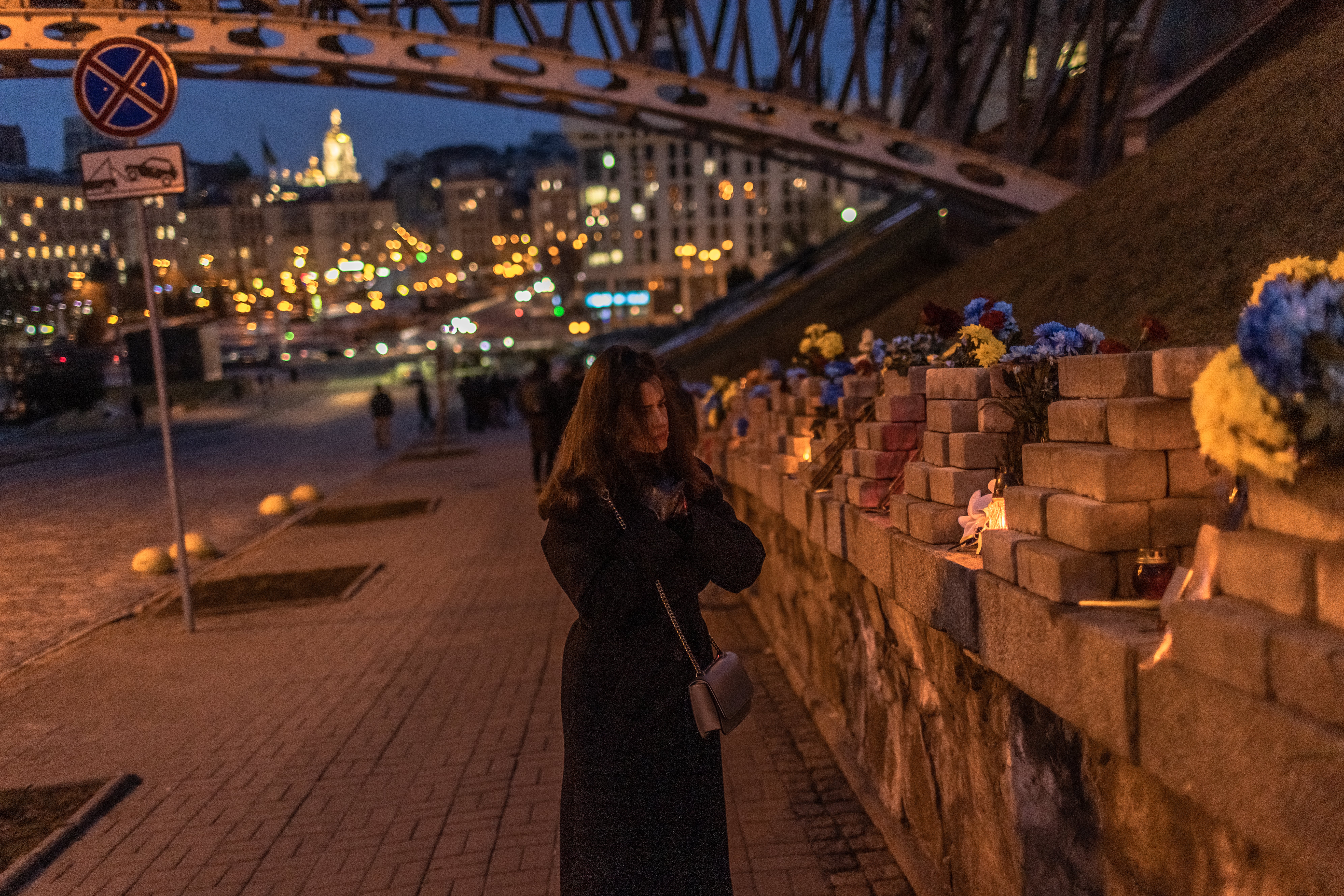 A woman visits the memorial to the Heavenly hundred heroes, who were killed in 2014 during the mass Euromaidan protests, on the Day of Remembrance of Heroes of Heavenly Hundred, on February 20, 2023 in Kyiv, Ukraine
