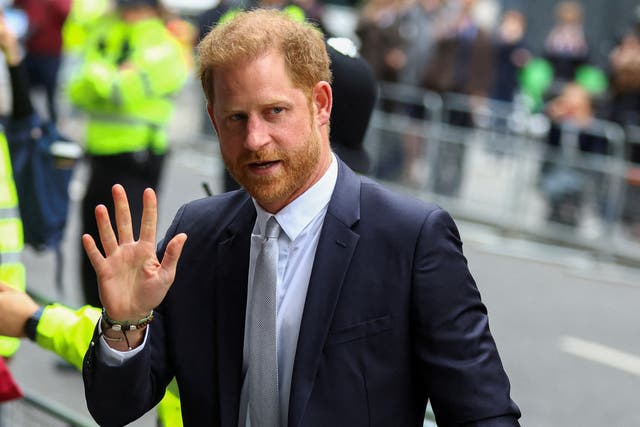 <p>Prince Harry walks outside the Rolls Building of the High Court in London in June</p>