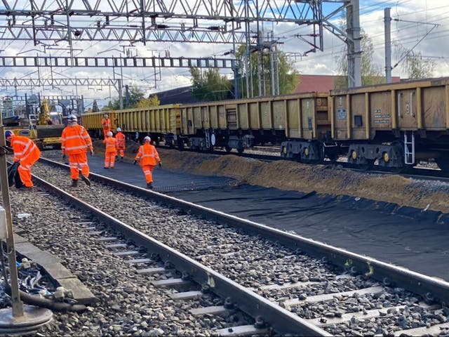 <p>Orange alert: Network Rail staff working on lines in the Midlands</p>