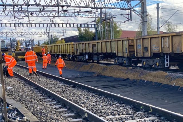 <p>Orange alert: Network Rail staff working on lines in the Midlands</p>