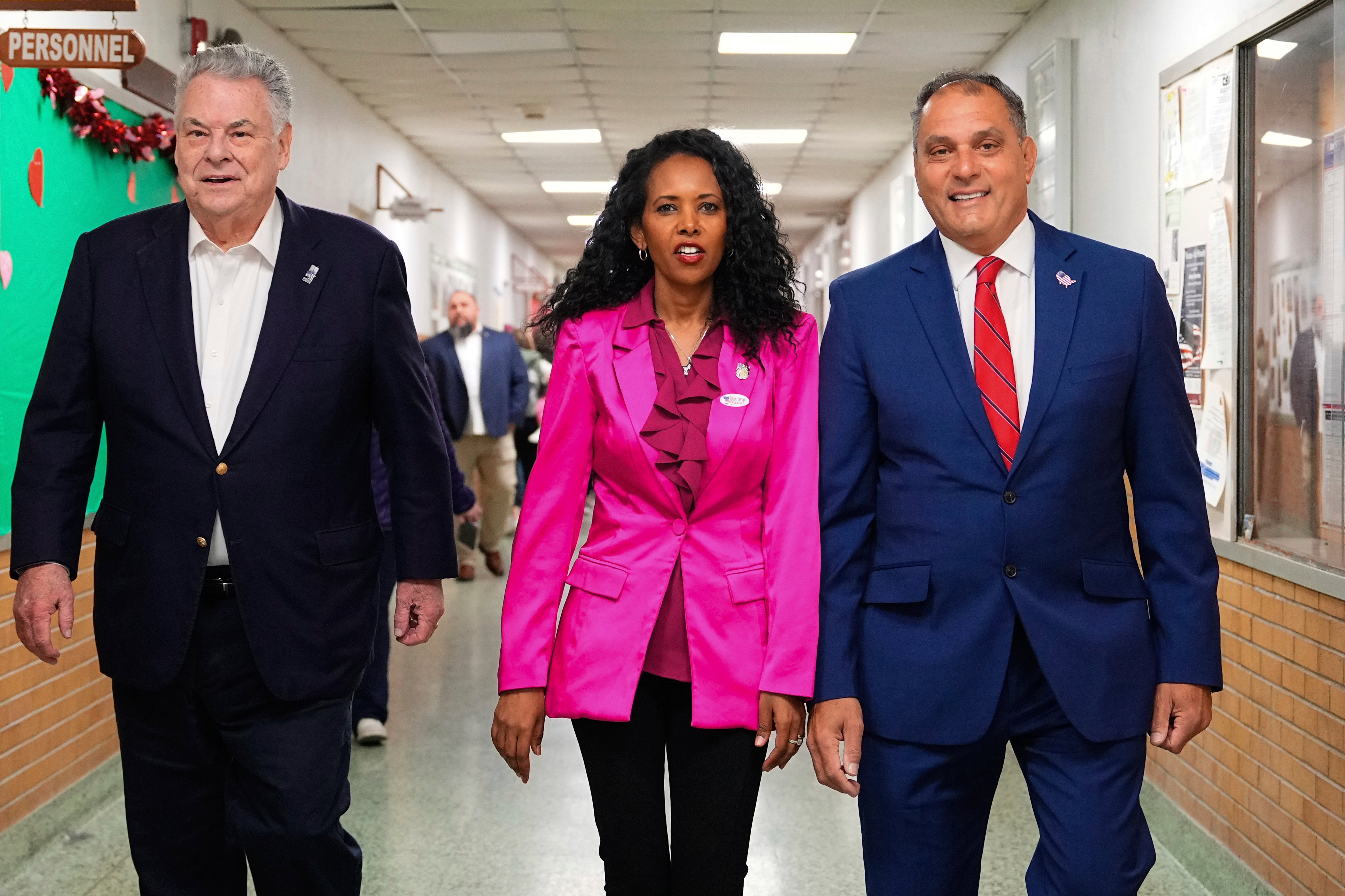 Mazi Pilip, centre, arrives to vote early at a polling station in Massapequa, New York, on Friday with former GOP congressman Peter King and Oyster Bay town supervisor Joseph Saladino