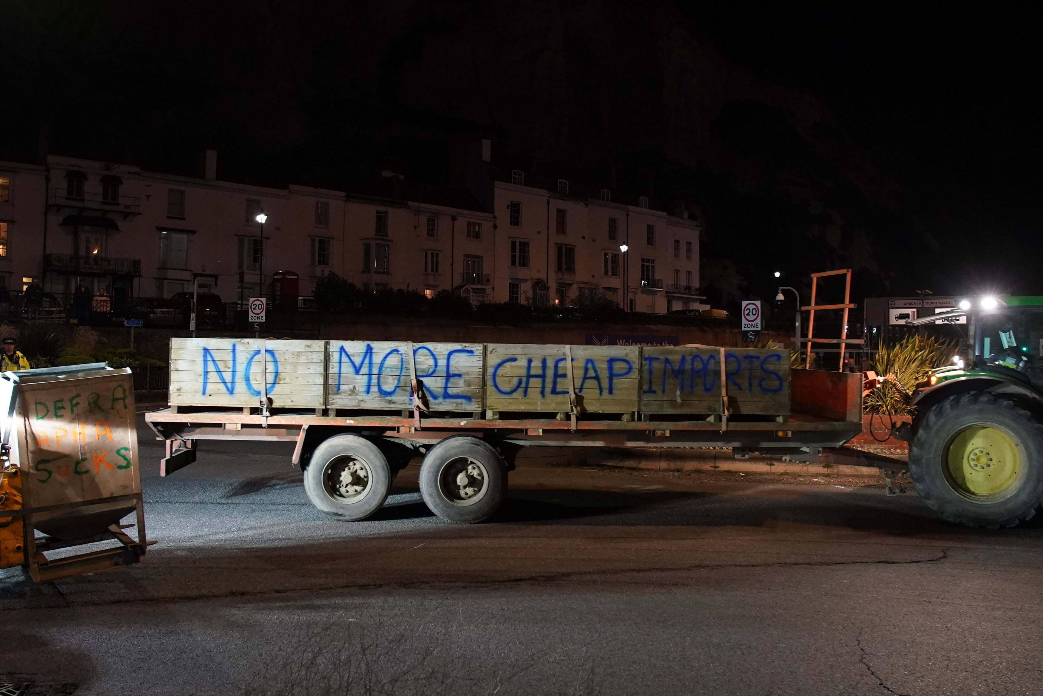 One tractor with a trailer had “no more cheap imports” spray painted on the side of it