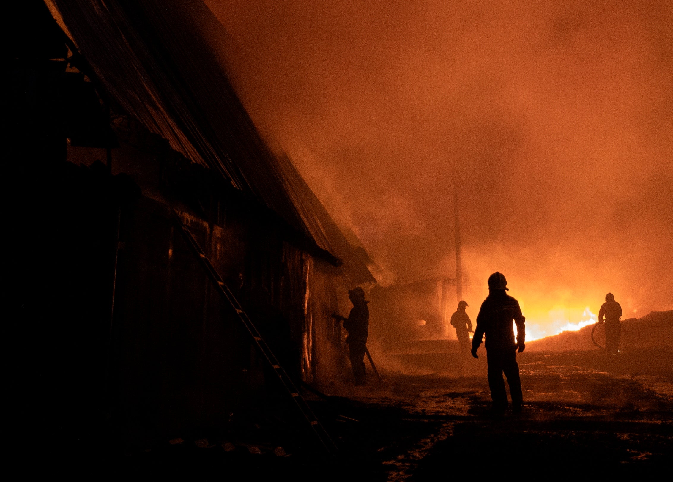 Rescue services work at the scene of a drone strike in the Eastern Ukrainian city of Kharkiv