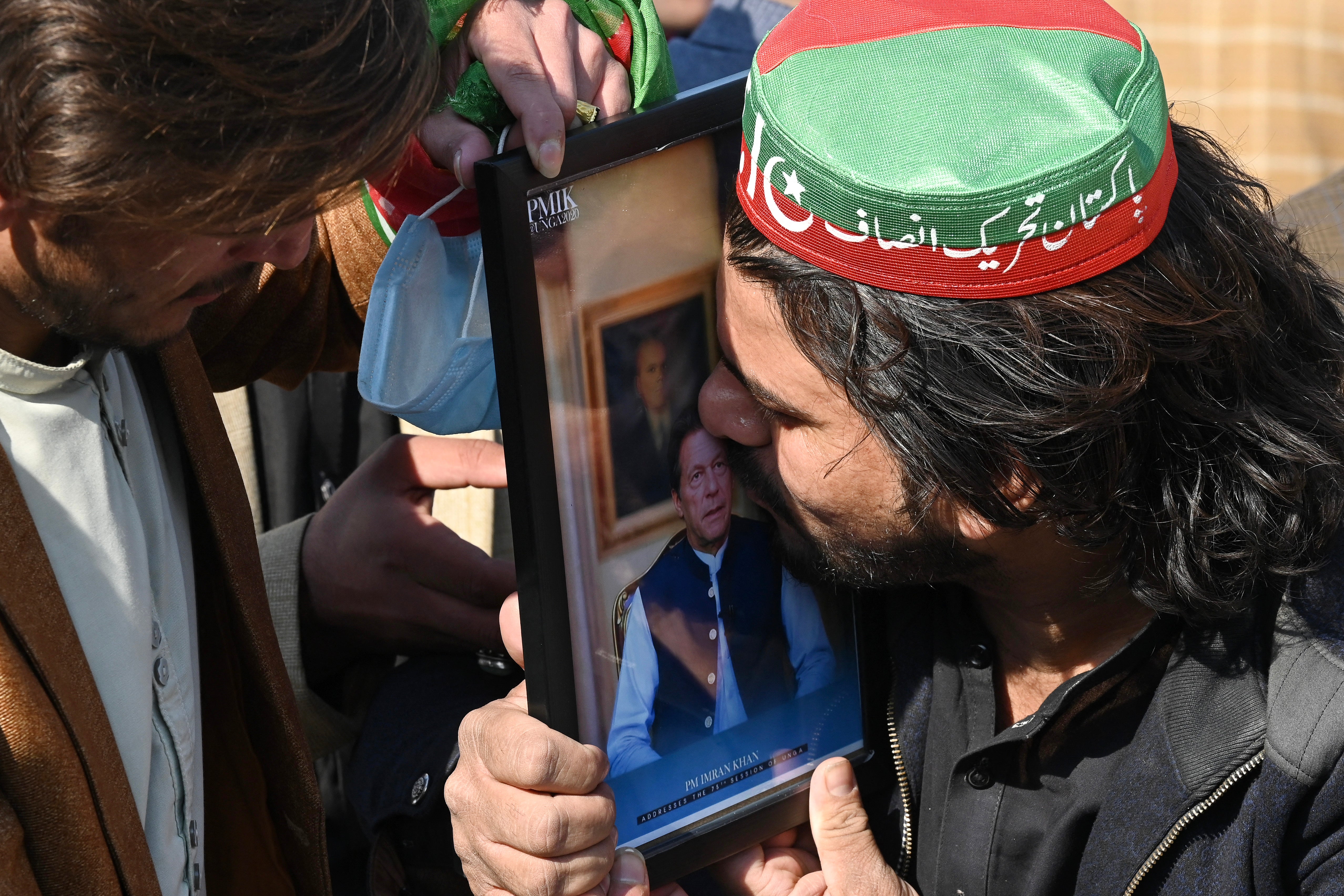 <p>A supporter of the Pakistan Tehreek-e-Insaf (PTI) kisses a portrait of jailed former prime minister and party leader Imran Khan during a protest in Peshawar on 10 February 2024</p>