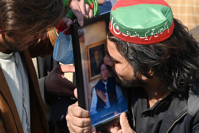 <p>A supporter of the Pakistan Tehreek-e-Insaf (PTI) kisses a portrait of jailed former prime minister and party leader Imran Khan during a protest in Peshawar on 10 February 2024</p>