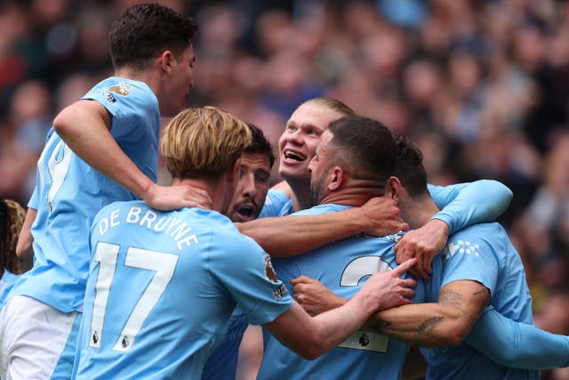 <p>Erling Haaland is swamped by his teammates after scoring </p>