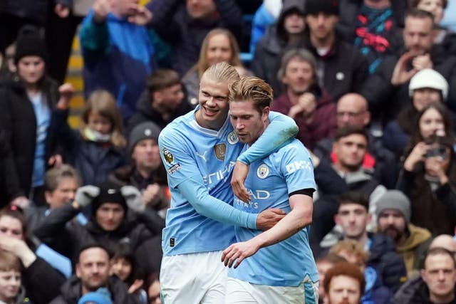 Erling Haaland, left, celebrates scoring his second goal with Kevin De Bruyne (Martin Rickett/PA)