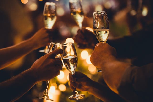 <p>Numerous hands holding champagne flutes with champagne celebratory toast silhouettes</p>