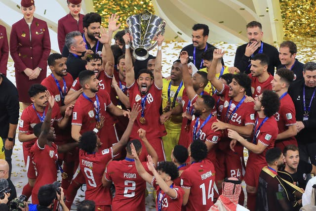 <p>Qatar celebrate with the trophy after victory at the Lusail Stadium</p>