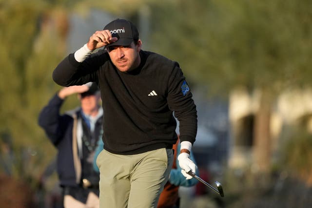 Nick Taylor, of Canada, watches his approach shot on the fifth hole during the third round of the Phoenix Open golf tournament (Ross D Franklin/AP)
